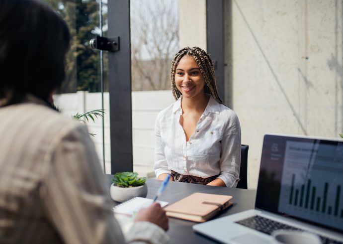 Happy young woman having job interview in office, business and career concept