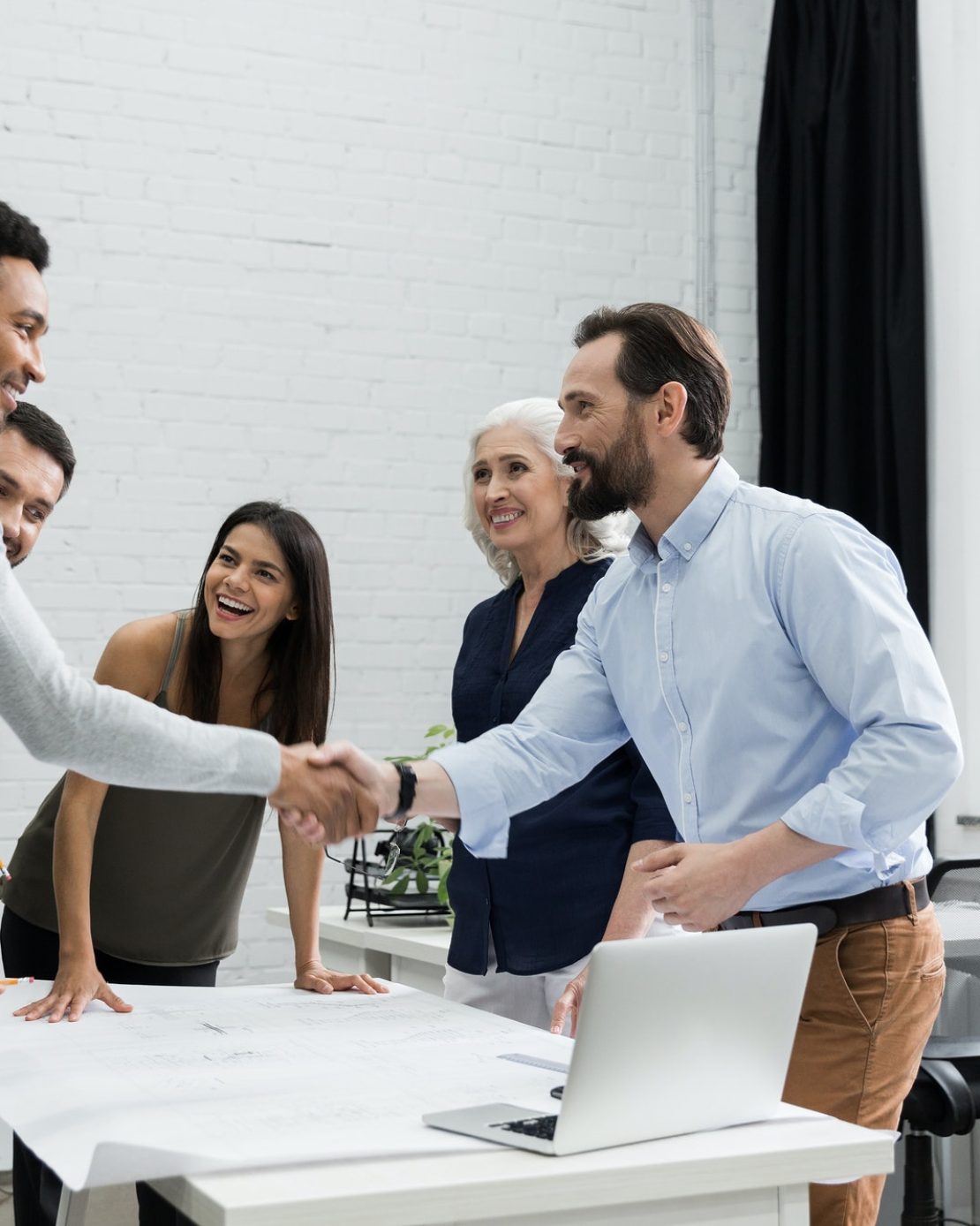 Two male executives shaking hands